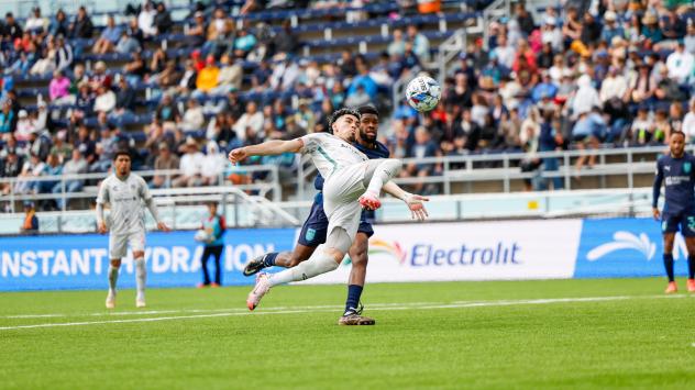 Oakland Roots go airborne for a ball against Monterey Bay FC