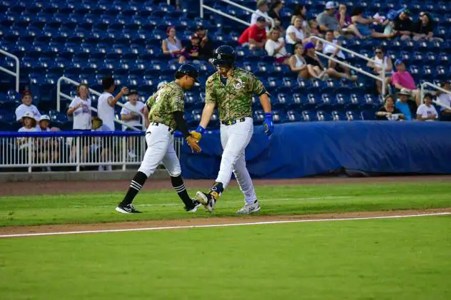 Biloxi Shuckers' Brock Wilken congratulated by teammate