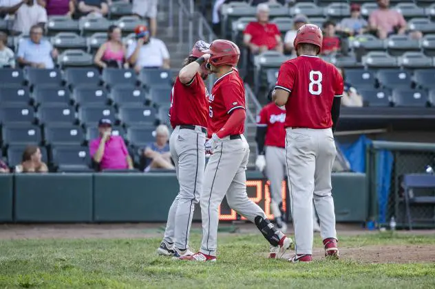 Scott Ota of the Sioux City Explorers celebrates with #8 Daniel Montano and Daniel Lingua following his three run home run