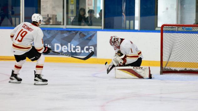 Vancouver Giants right wing Cameron Schmidt and goaltender Matthew Hutchison