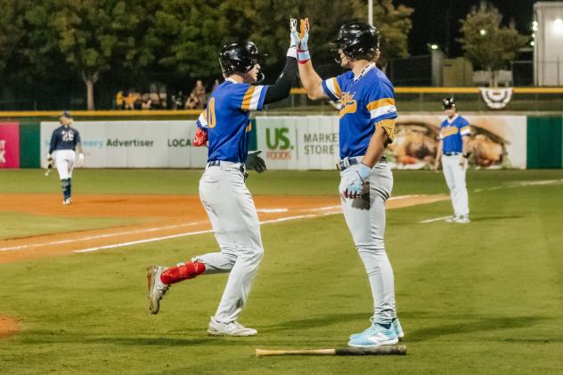 Biloxi Shuckers' Cooper Pratt congratulated by teammate