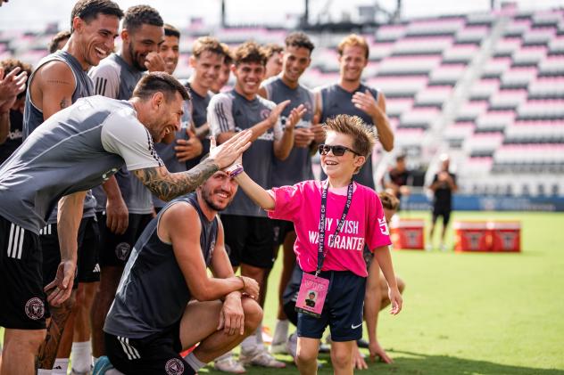 Inter Miami's Lionel Messi exchanges a high five during a Make-A-Wish experience