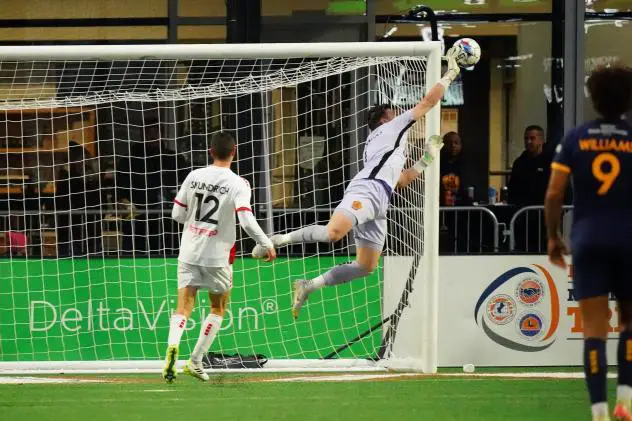 Rhode Island FC goalkeeper Koke Vegas swats away at Loudoun United FC shot