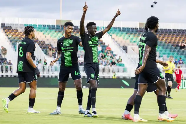 Lexington SC midfielder Ates Diouf celebrates