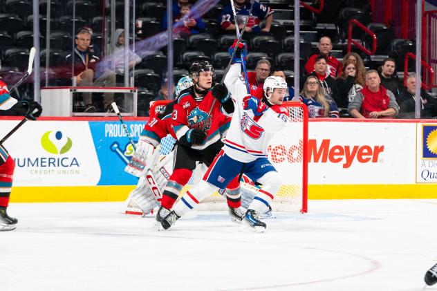 Ethan Mittelstadt of the Kelowna Rockets defends against the Spokane Chiefs