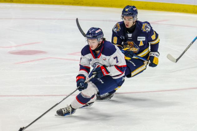 Saginaw Spirit's Calem Mangone and Erie Otters' Pano Fimis on the ice