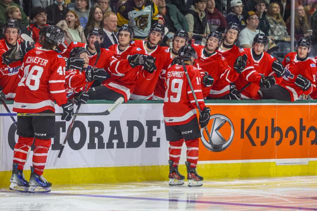 Cameron Schmidt receives high fives from the bench