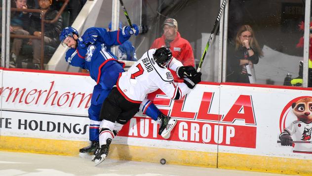 Adirondack Thunder forward Chase Brand lays a hit on the Trois-Rivieres Lions