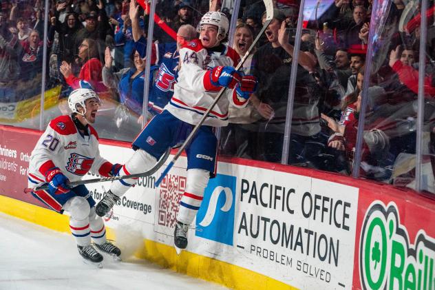 Spokane Chiefs left wing Shea Van Olm and defenseman Saige Weinstein (right) celebrate
