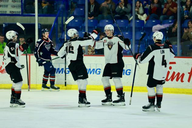 Vancouver Giants exchange congratulations after a goal against the Tri-City Americans