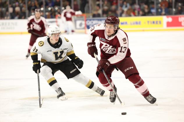 Peterborough Petes centre Gavin Bryant with the puck vs. the Kingston Frontenacs