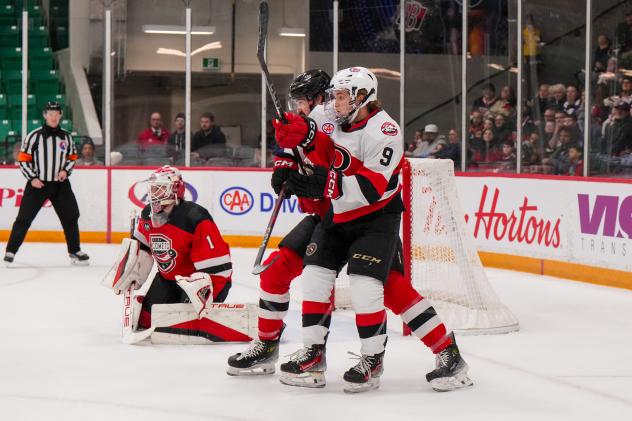 Belleville Senators left wing Angus Crookshank battles for position against the Utica Comets