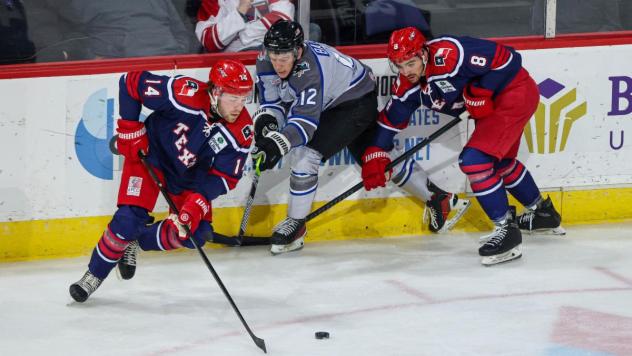 Wichita Thunder forward Peter Bates (center) vs. the Allen Americans