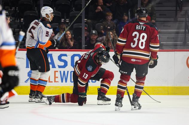 San Diego Gulls' Tyson Hinds and Tucson Roadrunners' Egor Sokolov and Aku Raty on game night