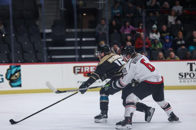 Tahoe Knight Monsters forward Jake McGrew (left) vs. the Adirondack Thunder