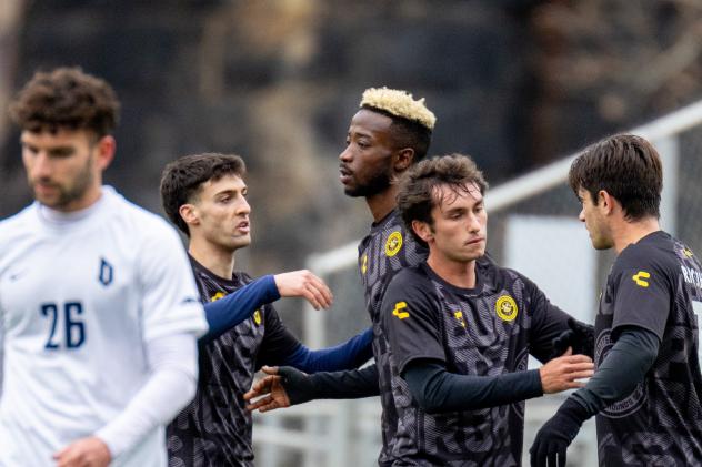 Pittsburgh Riverhounds exchange congratulations after scoring against Duquesne University
