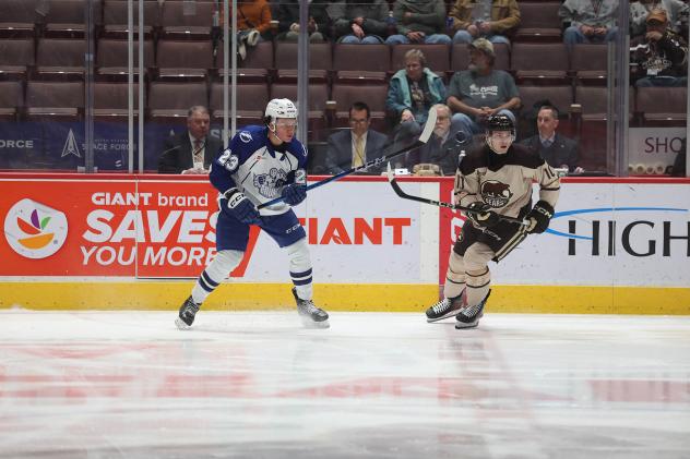 Syracuse Crunch's Maxim Groshev and Hershey Bears' Spencer Smallman on the ice