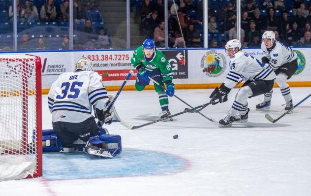 Wenatchee Wild's Brendan Gee, Lukas McCloskey, and Brendan Dunphy versus Swift Current Broncos' Carlin Dezainde