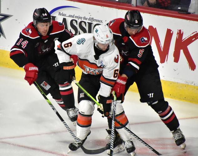 Brayden Guy and Hudson Wilson of the Allen Americans sandwich the Kansas City Mavericks