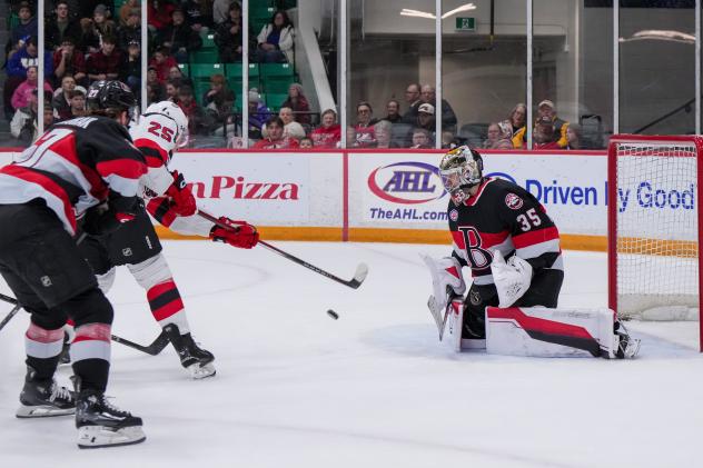 Belleville Senators goaltender Leevi Meriläinen eyes a shot from the Utica Comets