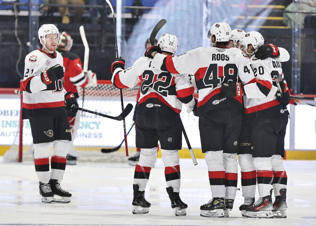 Belleville Senators huddle after a goal against the Utica Comets