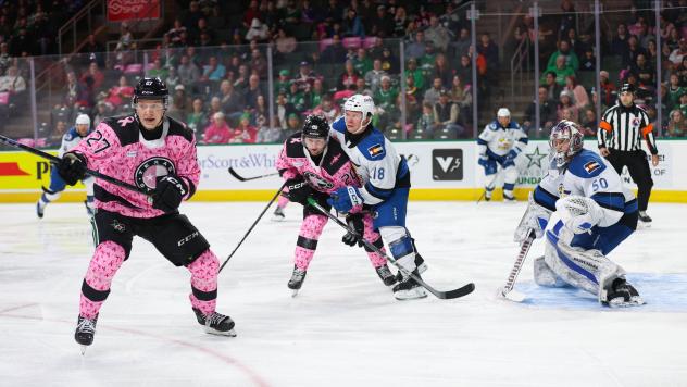 Texas Stars' Jack Becker and Mathias Emilio Pettersen battle Colorado Eagles' Jack Ahcan and Trent Miner