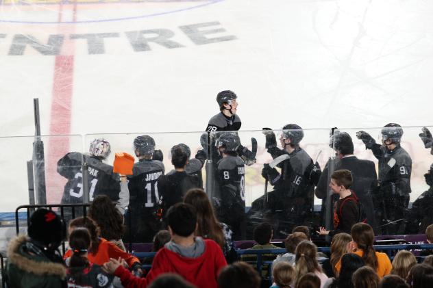 Youngstown Phantoms exchange high fives along the bench