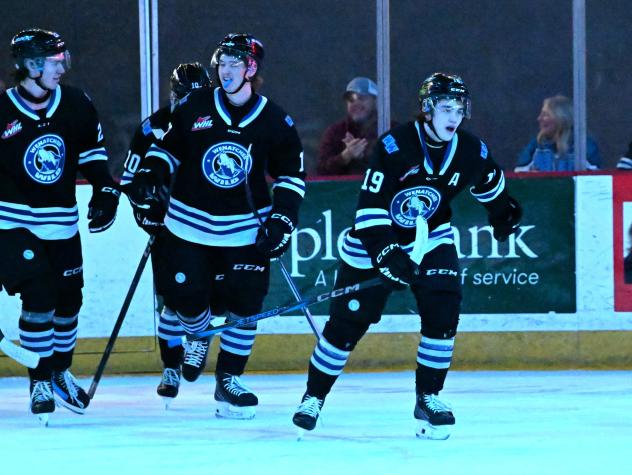 Wenatchee Wild forward Miles Cooper (right) leads his teammates to the bench following his goal