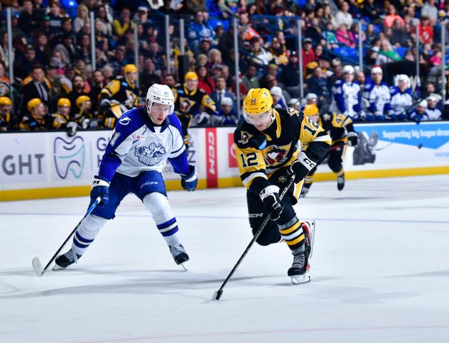Syracuse Crunch defenseman Derrick Pouliot (left) vs. the Wilkes-Barre/Scranton Penguins