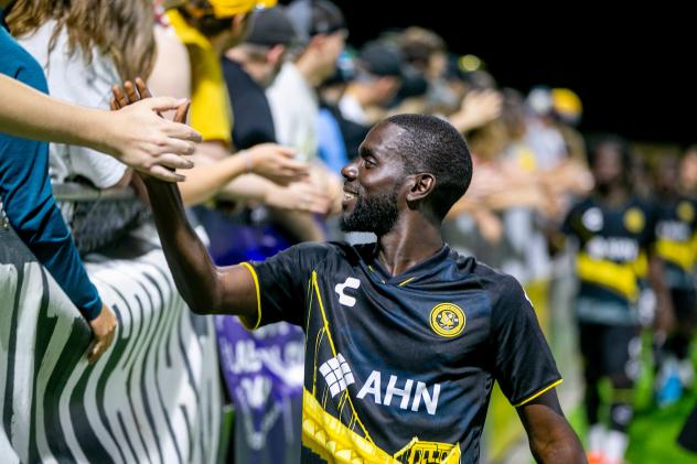 Kenardo Forbes of the Pittsburgh Riverhounds shakes hands with the fans