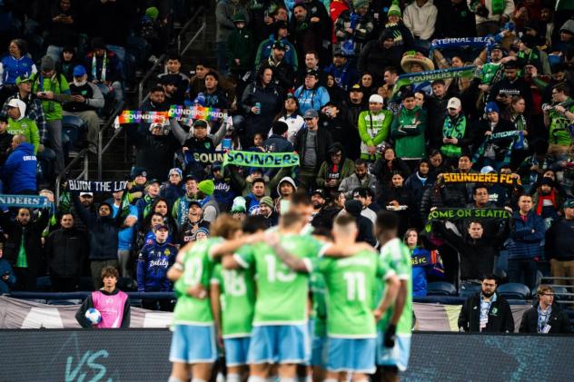 Sounders FC huddle in front of their fans