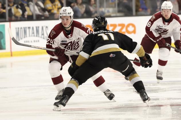 Peterborough Petes forward Braydon McCallum (left) vs. the Kingston Frontenacs