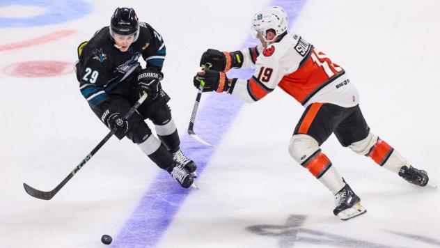 Wichita Thunder forward Luke Grainger (right) eyes the puck against the Kansas City Mavericks