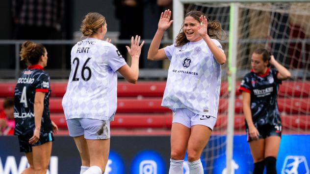 Racing Louisville FC midfielder Taylor Flint congratulates Emma Sears on her goal
