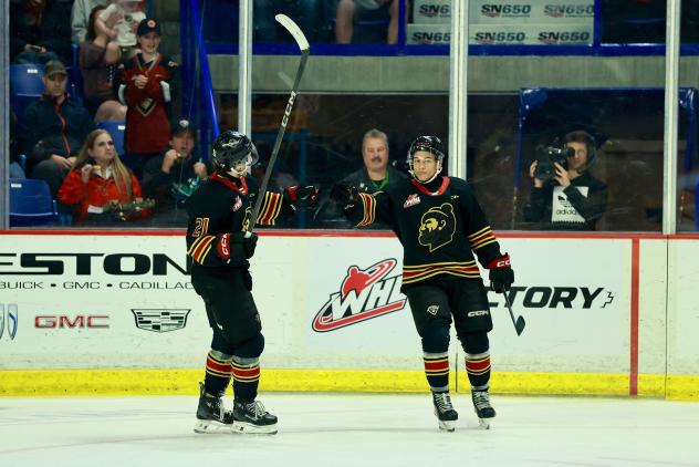 Vancouver Giants exchange a fist bump following a goal