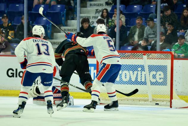 Vancouver Giants poke home a goal against the Spokane Chiefs