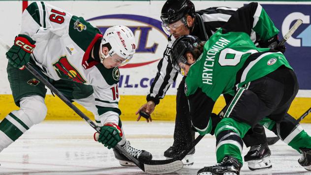Texas Stars forward Justin Hryckowian (right) faces off with the Iowa Wild
