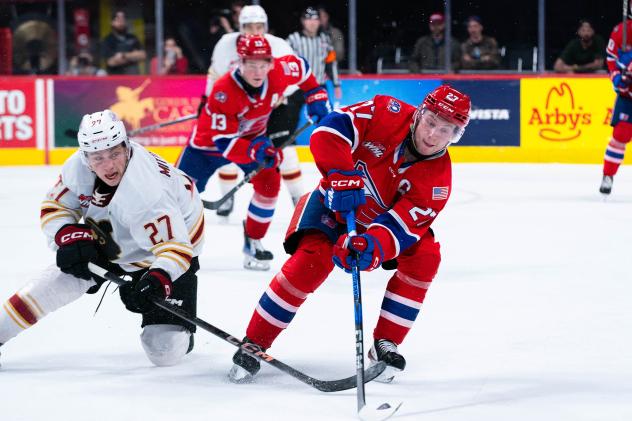 Vancouver Giants centre Kyren Gronick (left) vs. the Spokane Chiefs