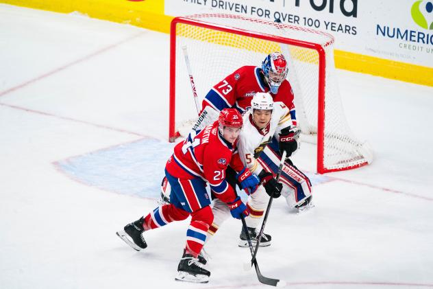 Vancouver Giants right wing Tyus Sparks fights for position by the Spokane Chiefs goal