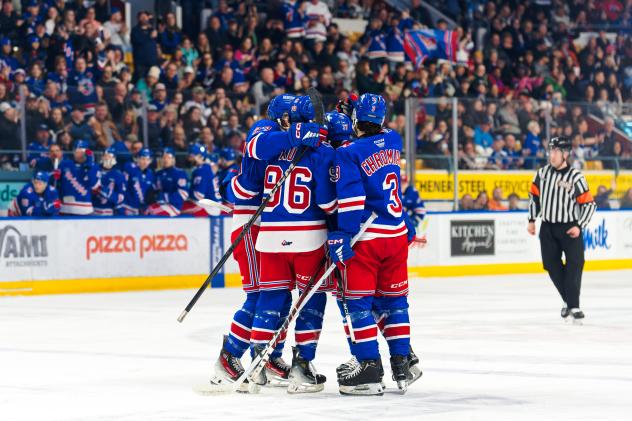 Kitchener Rangers Jacob Xu and Jakub Chromiak celebrate with teammates