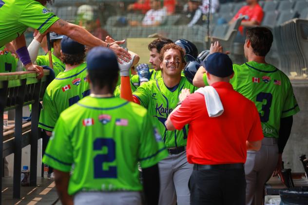 Osceola  Cougars exchange congratulations in the dugout