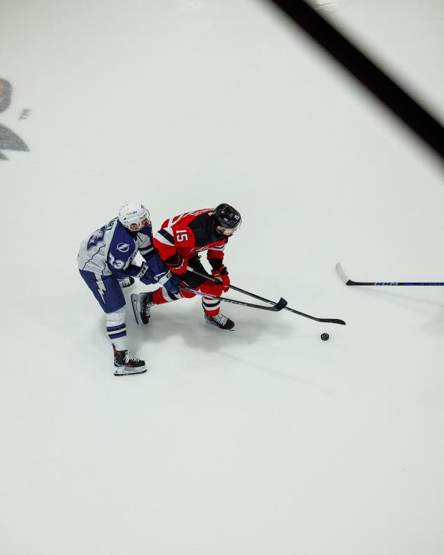 Syracuse Crunch left wing Conor Sheary (left) vs. the Utica Comets