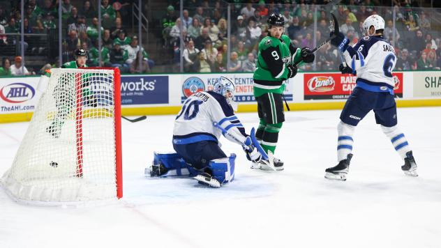 Manitoba Moose' Domenic DiVincentiis and Ashton Sautner and Texas Stars' Justin Hryckowian on the ice