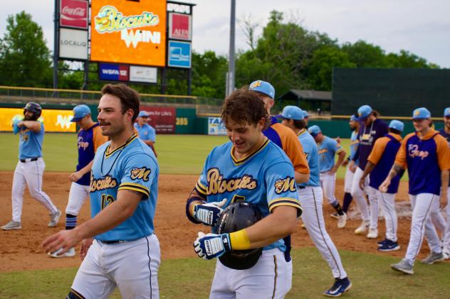 Colton Ledbetter (right) and the Montgomery Biscuits walk off the field