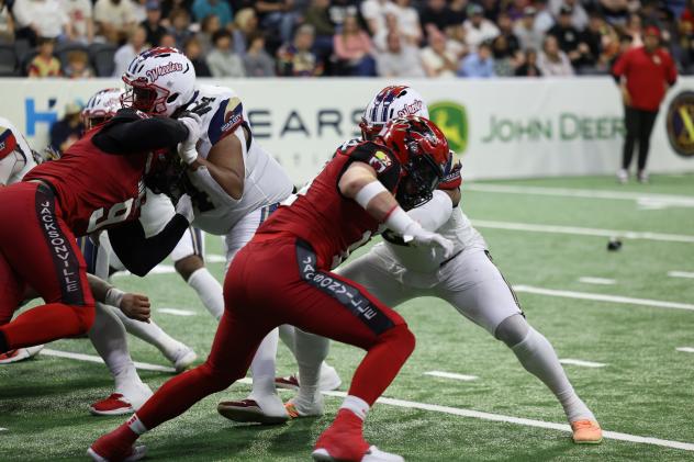 Jacksonville Sharks block against the Quad City Steamwheelers