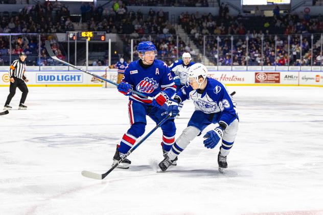 Syracuse Crunch defenseman Maxim Groshev (right) vs. the Rochester Americans