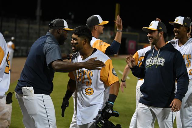 Columbia Fireflies greet Angel Acosta after his walk-off double