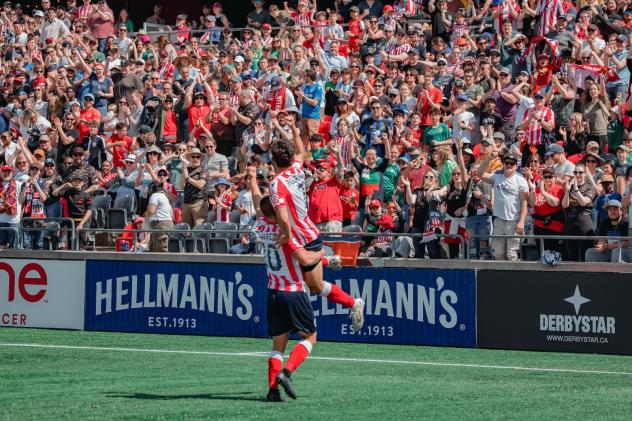 David Rodríguez and Manu Aparicio of Atlético Ottawa celebrate
