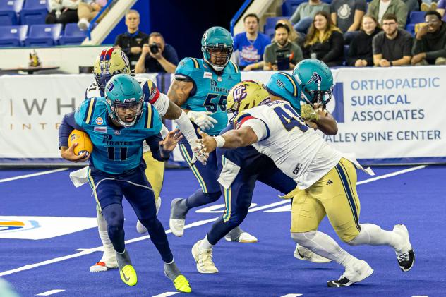 Massachusetts Pirates quarterback Kenji Bahar on the run