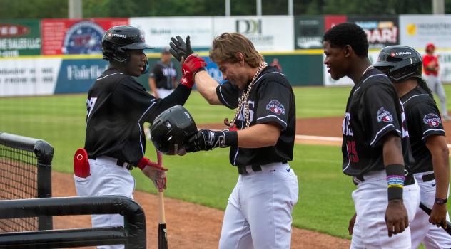 Hickory Crawdads congratulate Maxton Martin after his home run